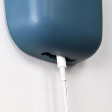 Wall-mounted charging holder.